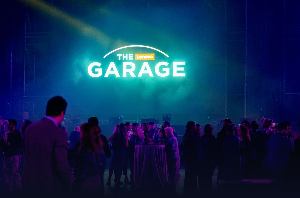 Invitados bajo el rótulo luminoso de The Lenovo Garage